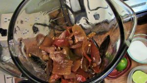 Blending red chilies after cooking for an hour. Add salt and lime, and serve with enchiliadas, tamales, and tofu.