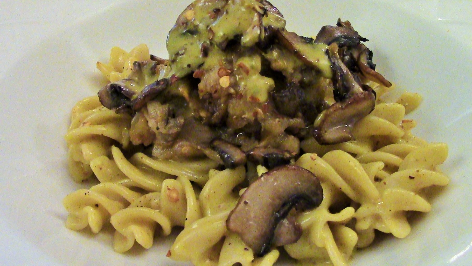 Smoked Coconut Curry Sauce over gluten free fusilli, with roasted and sauteed onions and eggplant. Topped with sauteed mushrooms.